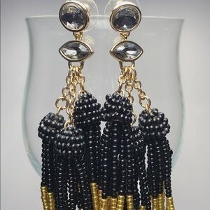 Gold and black dangling BP earrings